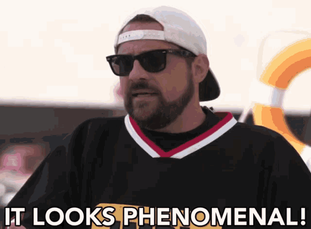 a man with a beard wearing sunglasses and a hat says " it looks phenomenal "