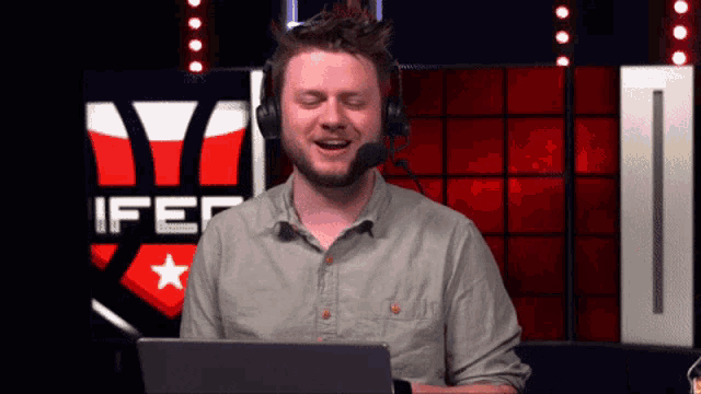 a man wearing headphones and a microphone in front of a ifer logo