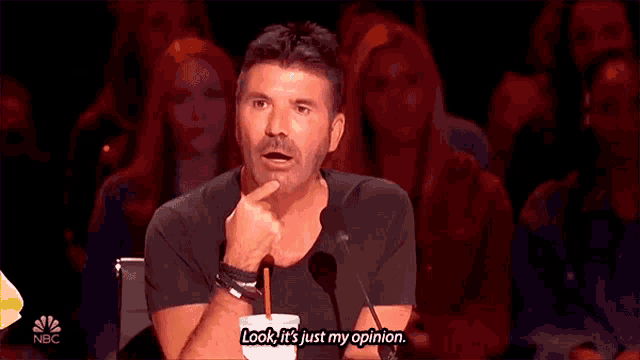 a man is giving a speech in front of a crowd and says look it 's just my opinion .