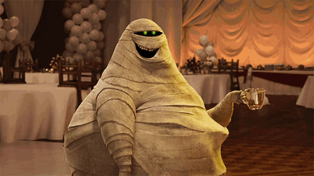 a cartoon mummy is holding a cup of coffee