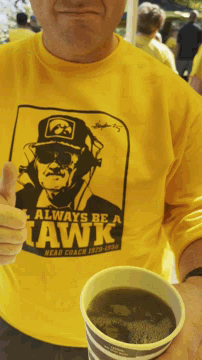 a man wearing a shirt that says always be a hawk
