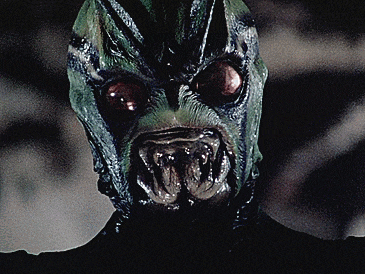 a close up of a monster 's face with sharp teeth
