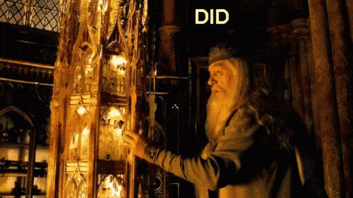 a man with a beard stands in front of a sign that says " did "