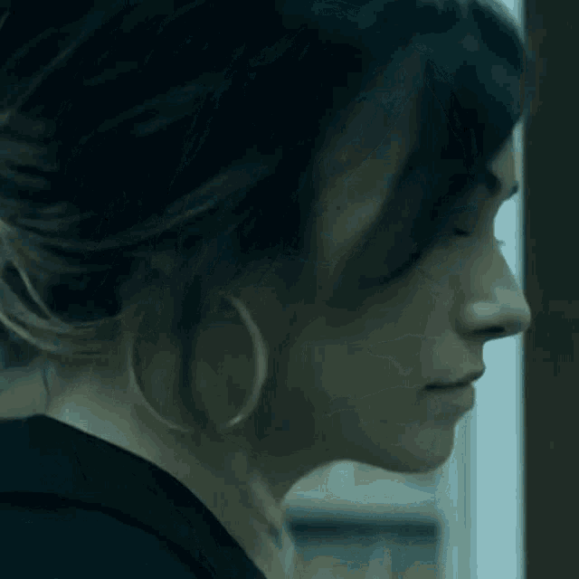 a close up of a woman 's face with a serious look on her face .