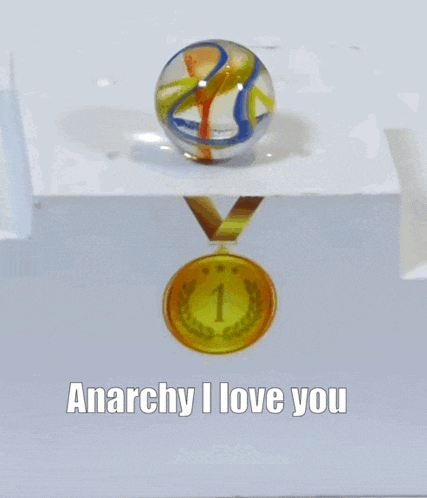 a marble sitting on top of a podium with a gold medal and the words anarchy i love you