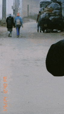 a group of people walking down a dirt road with a photo taken on 6/24 at 12:40 pm