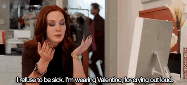 a woman refuses to be sick and is wearing valentino