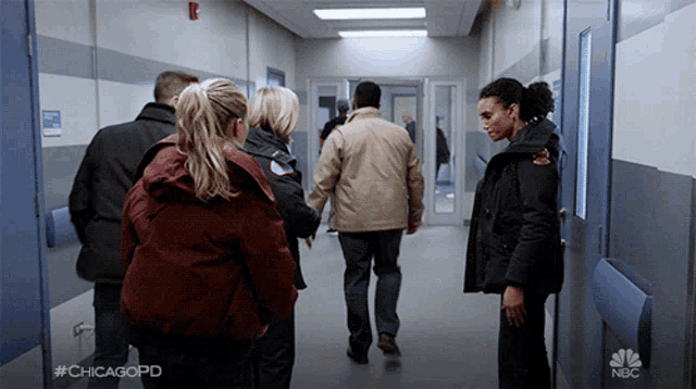 a group of people walking down a hallway with the hashtag #chicagopd on the bottom