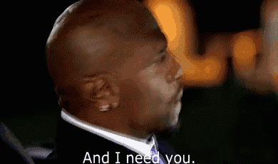a bald man in a suit and tie is saying `` and i need you . ''