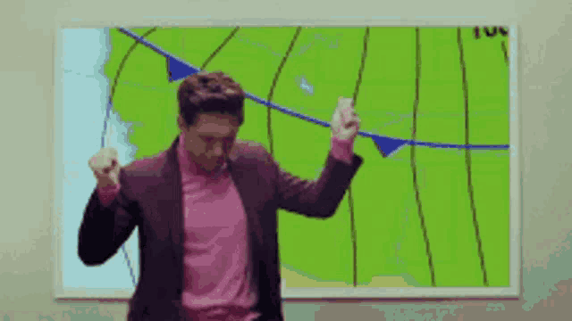 a man is dancing in front of a weather map