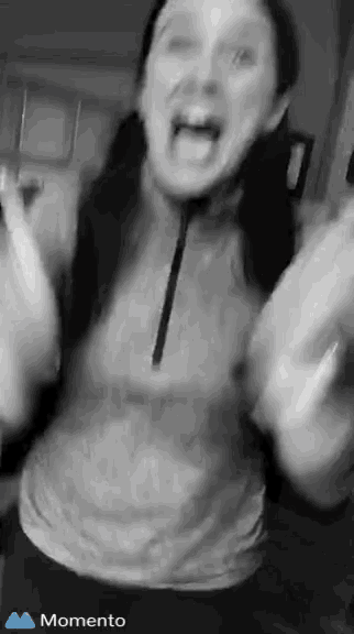 a woman is making a funny face in a black and white photo with the word momento in the corner