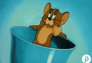 a cartoon mouse named jerry is sitting in a blue cup