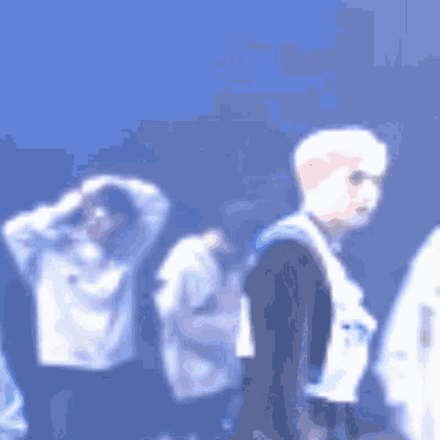 a blurry picture of a group of people with one wearing a shirt that says ' nc ' on it