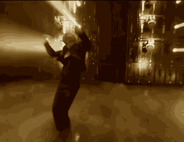a blurred image of a person dancing in a dark room