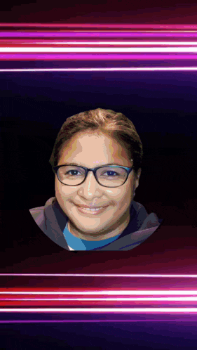a woman wearing glasses and a blue shirt is smiling in front of a purple background