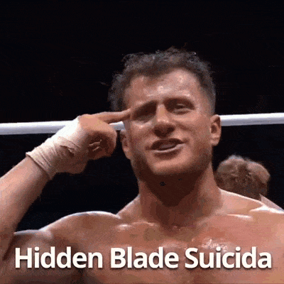 a man in a boxing ring is pointing at his forehead with the words `` hidden blade suicida '' written below him