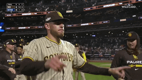 a man wearing a san diego jersey is giving the middle finger