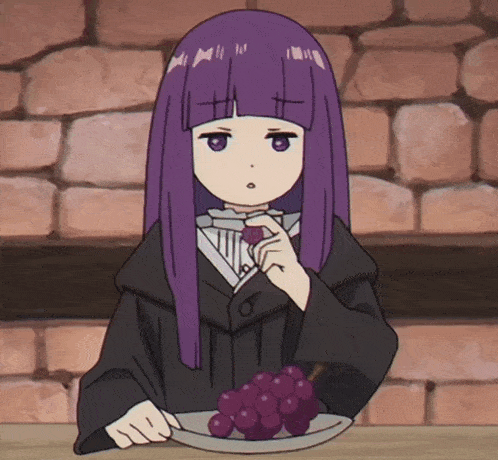 a girl with purple hair is eating grapes from a plate