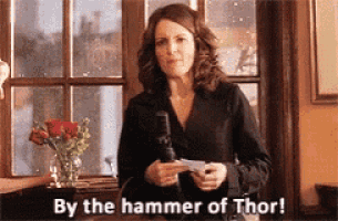 a woman is holding a microphone and says by the hammer of thor