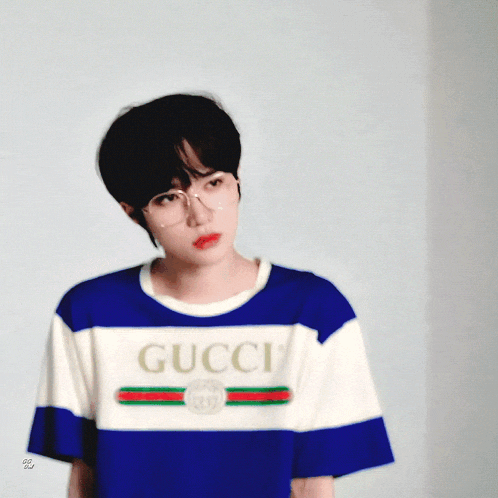 a person wearing a blue and white gucci t-shirt