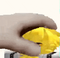 a close up of a person holding a yellow object .