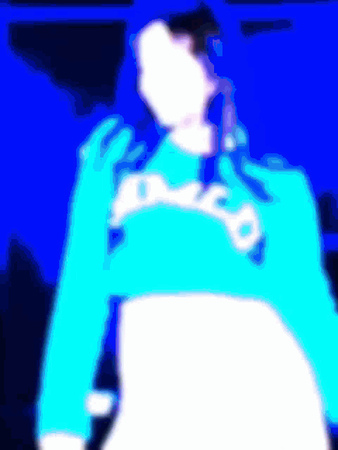 a blurry picture of a person wearing a blue sweater with the word disco on it