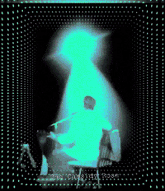 a man in a white shirt is sitting in a chair in front of a light that says the captain rose
