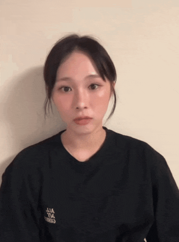 a woman wearing a black t-shirt that says ' ulia ' on it