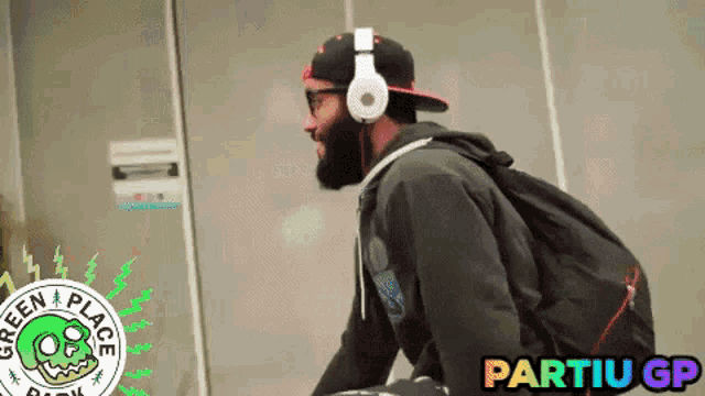 a man wearing headphones and a hat with partiu gp on the bottom right