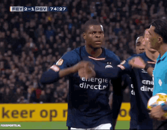 a soccer player wearing a blue shirt that says energie direct on it
