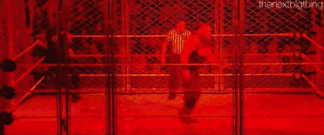 a blurry picture of a person standing in a ring with a red background .