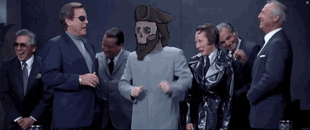 a group of men in suits are laughing at a man with a skull head