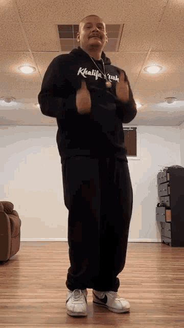 a man in a black hoodie that says khalifah rush