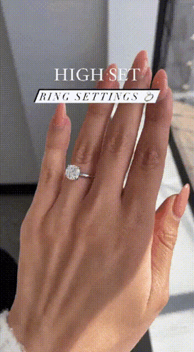 a close up of a woman 's hand with a high set ring