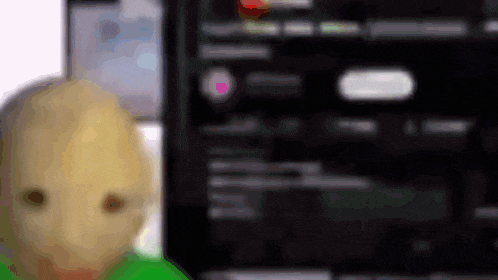 a blurred image of a person 's face with a green shirt on