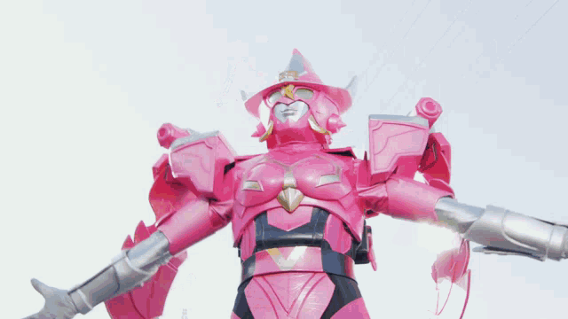 a pink robot with wings is holding a blue object in its hands .