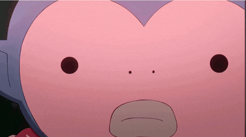 a close up of a pink cartoon character 's face with two black dots on it