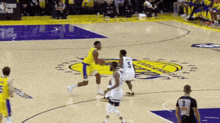 a group of basketball players are playing a game of basketball on a basketball court .