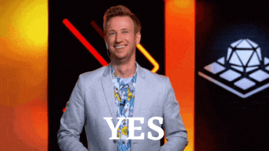 a man in a suit says yes in front of a black background