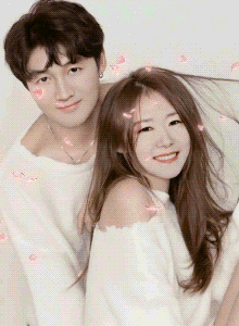 a man and woman are posing for a picture and the woman is wearing a white off the shoulder top