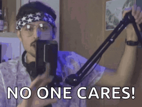a man wearing a headband and glasses holds a microphone and says " no one cares "