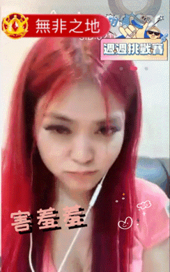 a woman with red hair is wearing headphones and has chinese writing on her face