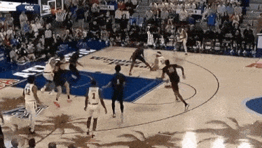 a group of basketball players are playing on a court .