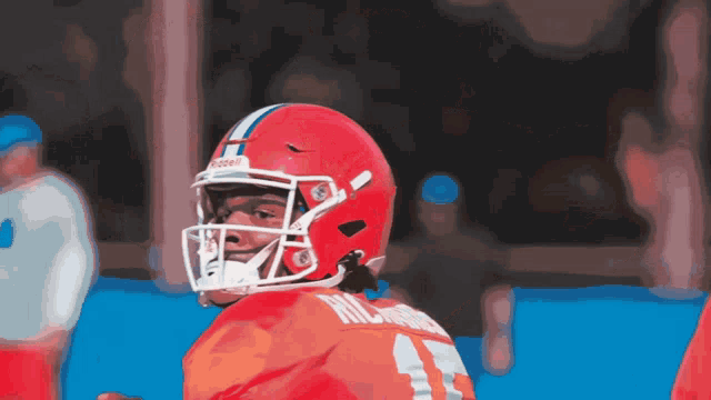 a football player wearing a red helmet has the number 1 on his jersey