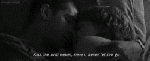 a black and white photo of a man and woman kissing with the words " kiss me and never never never let me go "