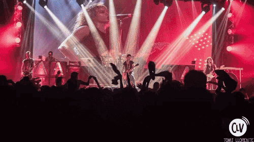 a group of people playing instruments on a stage with a sign that says toni lloret