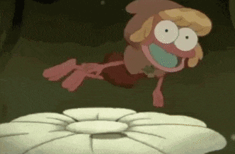 a cartoon character is sitting on top of a pile of rocks and smiling .