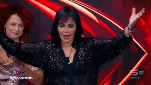 a woman in a sequined top is dancing on a television show