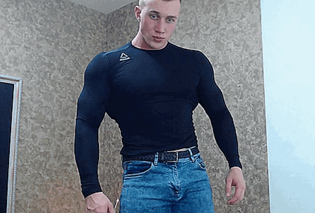 a man wearing a black shirt with a reebok logo on the front
