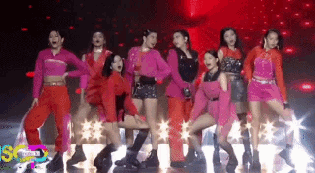 a group of women are dancing on a stage with a watermark that says sg from b